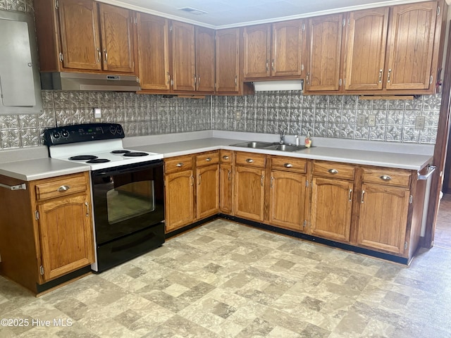 kitchen featuring a sink, light countertops, under cabinet range hood, black range with electric cooktop, and backsplash