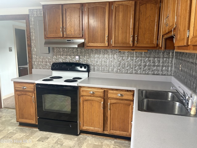 kitchen featuring electric stove, light countertops, a sink, and under cabinet range hood