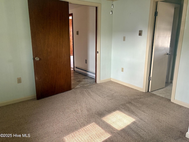 unfurnished bedroom featuring carpet floors, baseboards, and baseboard heating