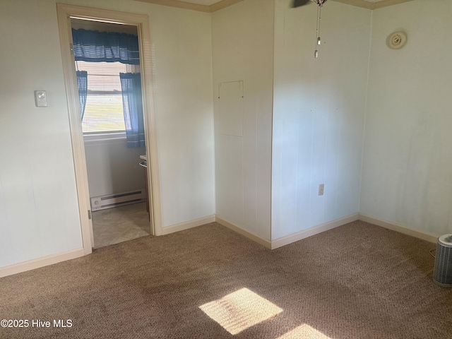 carpeted spare room featuring baseboard heating and baseboards