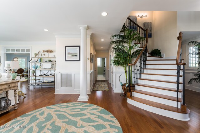 interior space featuring stairs, decorative columns, wood finished floors, elevator, and recessed lighting