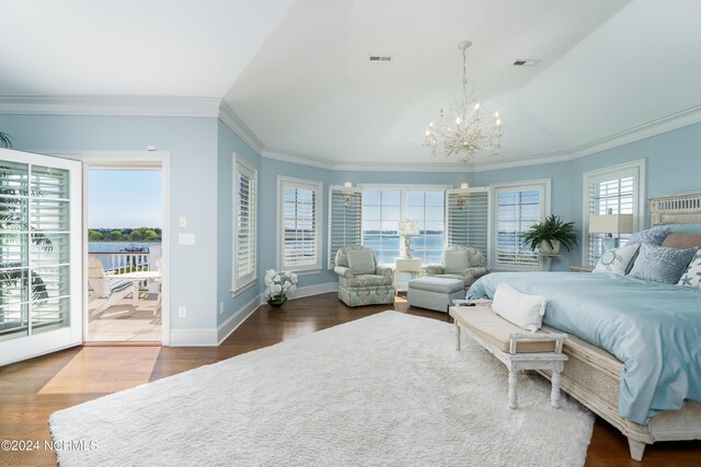 sitting room with wood finished floors, lofted ceiling, baseboards, a water view, and ornamental molding