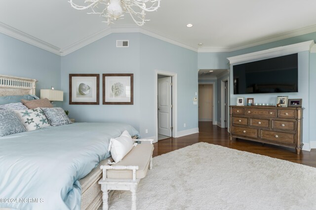 bedroom featuring visible vents, wood finished floors, lofted ceiling, and ornamental molding