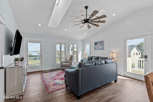 living area with a skylight, recessed lighting, dark wood-style floors, and ceiling fan