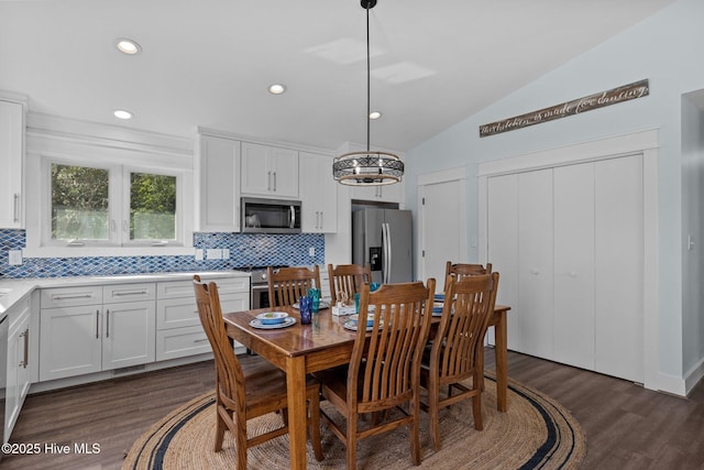 dining room featuring dark wood finished floors, vaulted ceiling, and recessed lighting