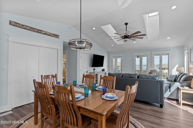 dining room featuring visible vents, lofted ceiling with skylight, a ceiling fan, dark wood finished floors, and recessed lighting