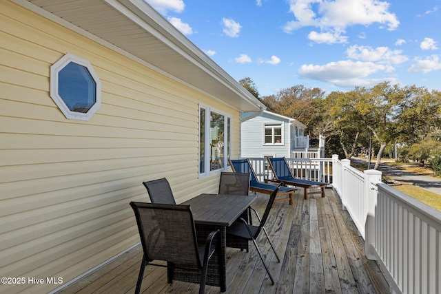 deck with outdoor dining area