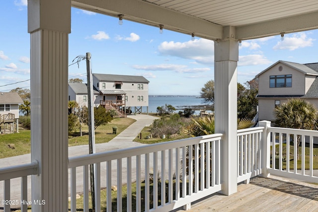 wooden terrace featuring a water view