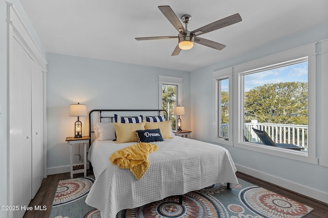 bedroom with ceiling fan, a closet, baseboards, and wood finished floors