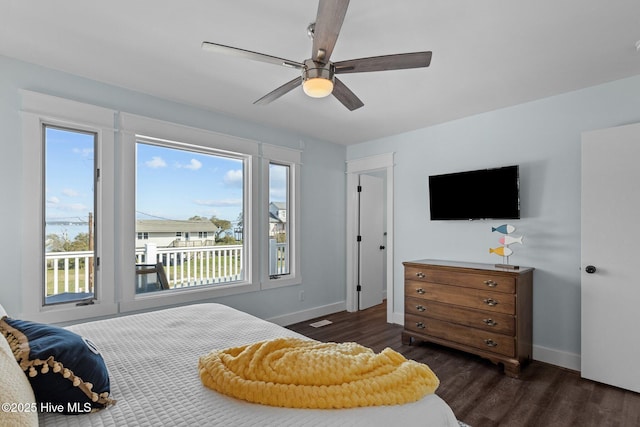 bedroom featuring a ceiling fan, dark wood-style floors, and baseboards