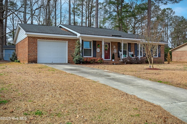 ranch-style home with a porch, a garage, brick siding, driveway, and a front yard