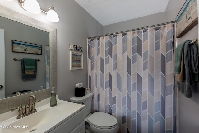 full bathroom with a shower with shower curtain, vanity, and toilet