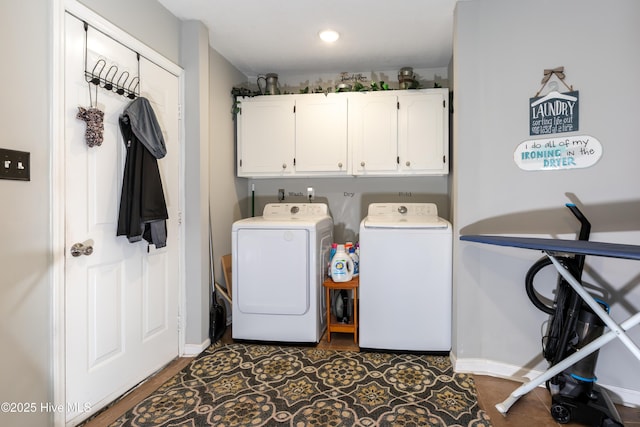 laundry area featuring cabinet space, baseboards, and independent washer and dryer