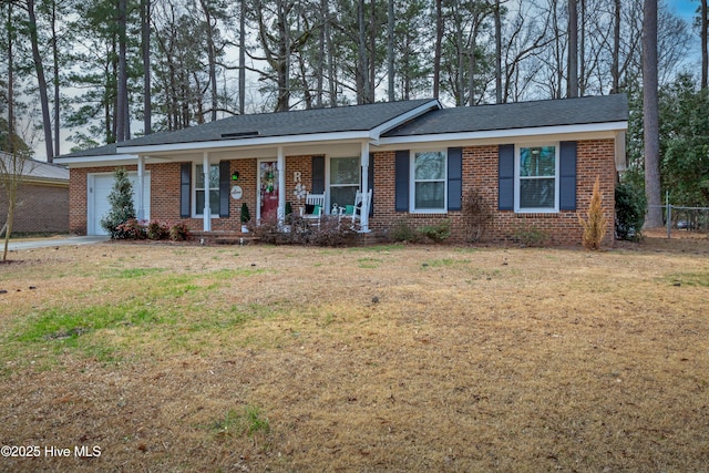 single story home with covered porch, brick siding, a front lawn, and an attached garage