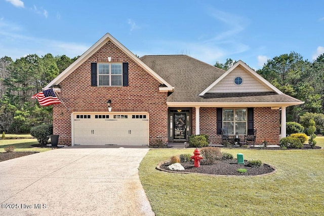 traditional home featuring roof with shingles, a front yard, concrete driveway, and brick siding