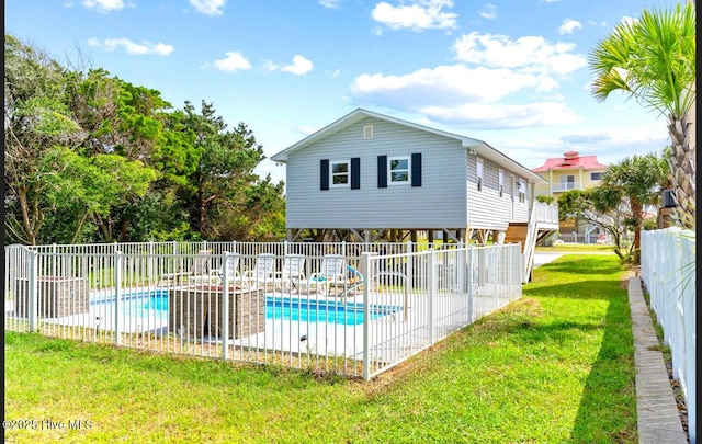 220 W Dolphin Dr, Oak Island, NC 28465 - rear view of house with a patio area