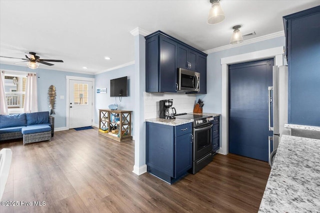 220 W Dolphin Dr, Oak Island, NC 28465 - kitchen featuring appliances with stainless steel finishes, blue cabinets, ornamental molding, dark wood-style flooring, and recessed lighting