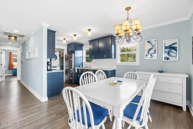220 W Dolphin Dr, Oak Island, NC 28465 - dining space with crown molding, a chandelier, dark wood-type flooring, baseboards, and recessed lighting