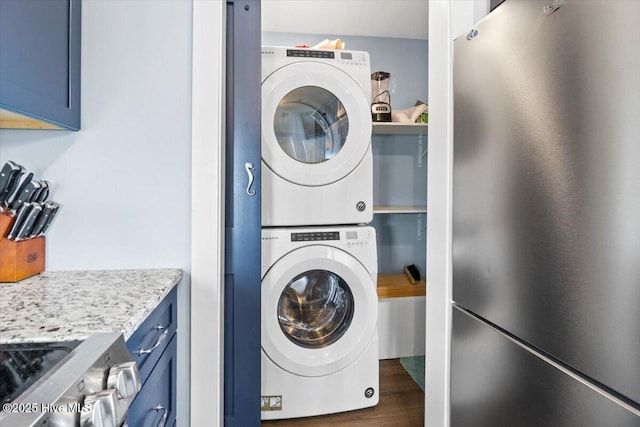 220 W Dolphin Dr, Oak Island, NC 28465 - laundry room with stacked washer and clothes dryer and wood finished floors