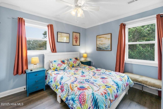 220 W Dolphin Dr, Oak Island, NC 28465 - bedroom with multiple windows, dark wood-type flooring, baseboards, ornamental molding, and a ceiling fan