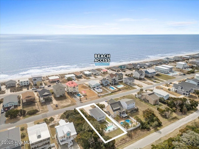 220 W Dolphin Dr, Oak Island, NC 28465 - aerial view of residential area with property parcel outlined and unending shoreline