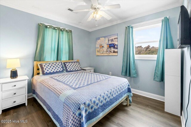 220 W Dolphin Dr, Oak Island, NC 28465 - bedroom featuring baseboards, wood finished floors, ornamental molding, and ceiling fan