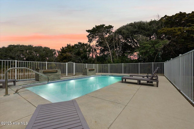 pool at dusk featuring a fenced in pool, a patio, and fence