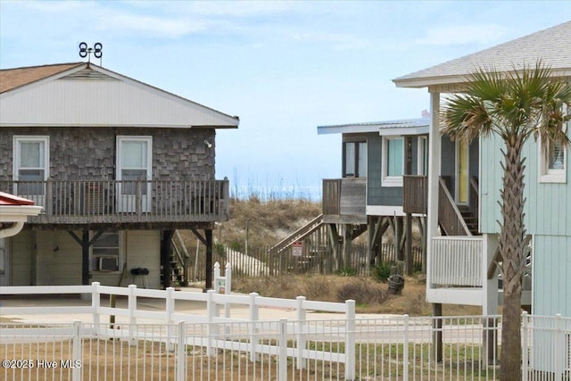 220 W Dolphin Dr, Oak Island, NC 28465 - view of side of property featuring stairway and fence