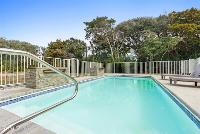 220 W Dolphin Dr, Oak Island, NC 28465 - view of pool with view of wooded area and fence