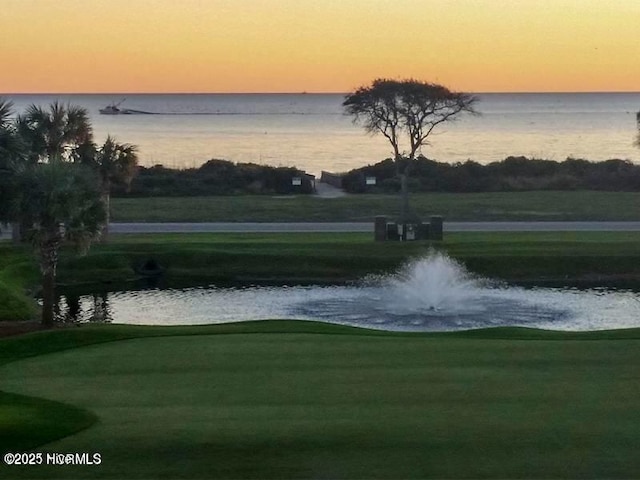220 W Dolphin Dr, Oak Island, NC 28465 - view of property's community with a water view, golf course view, and a yard