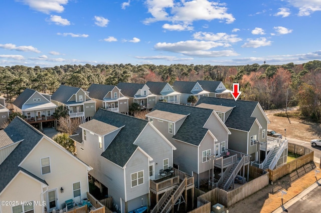 birds eye view of property featuring a residential view and a view of trees