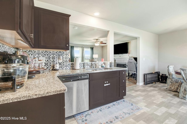 kitchen with dishwasher, dark brown cabinets, ceiling fan, and a sink