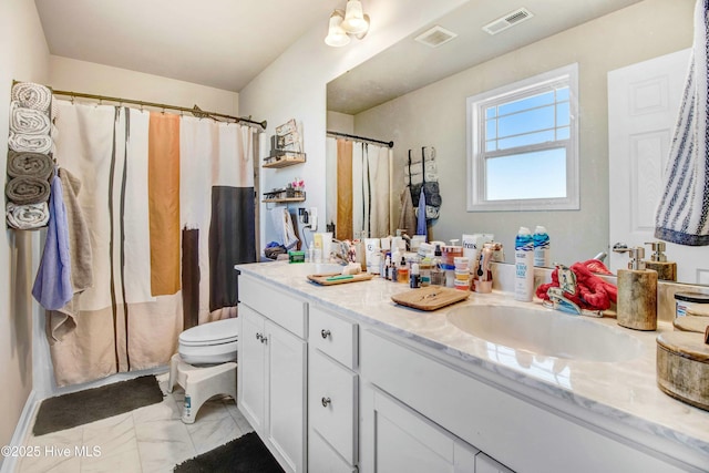 bathroom featuring double vanity, visible vents, toilet, marble finish floor, and a sink