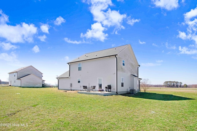 rear view of property with cooling unit, a patio area, and a yard