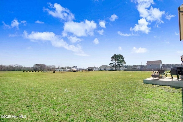 view of yard with fence and a patio