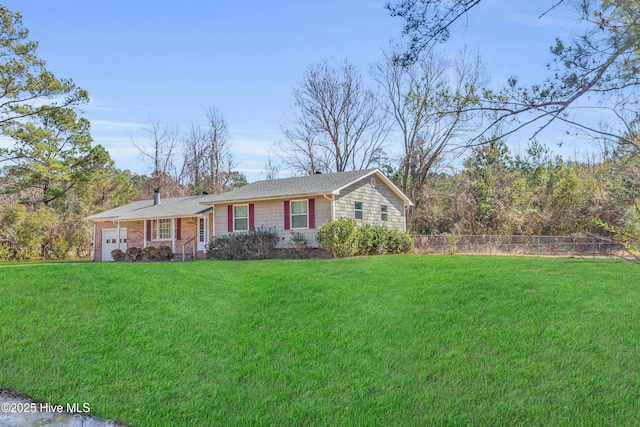 ranch-style home featuring a garage, a front yard, and fence