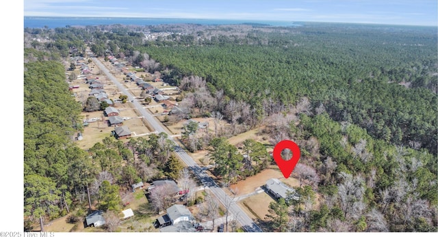 birds eye view of property with a wooded view