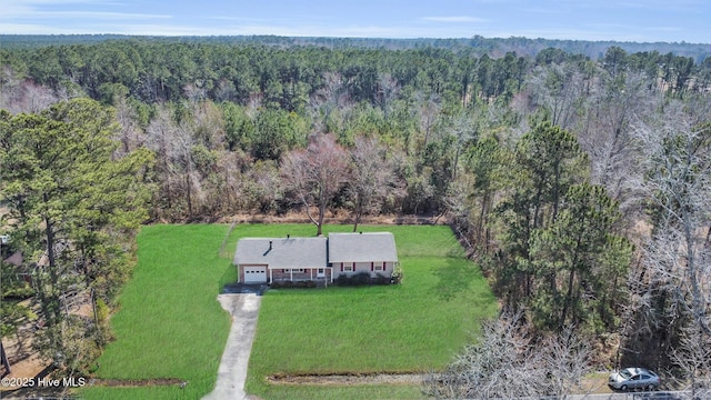 drone / aerial view featuring a wooded view