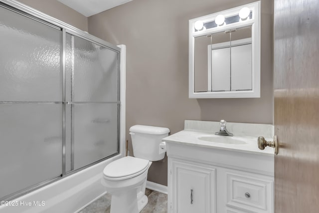 full bathroom with baseboards, vanity, toilet, and bath / shower combo with glass door