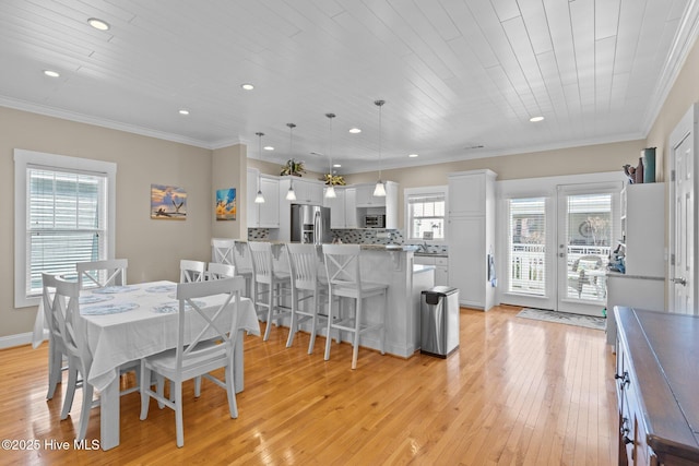 dining space featuring recessed lighting, light wood-style flooring, ornamental molding, and wooden ceiling