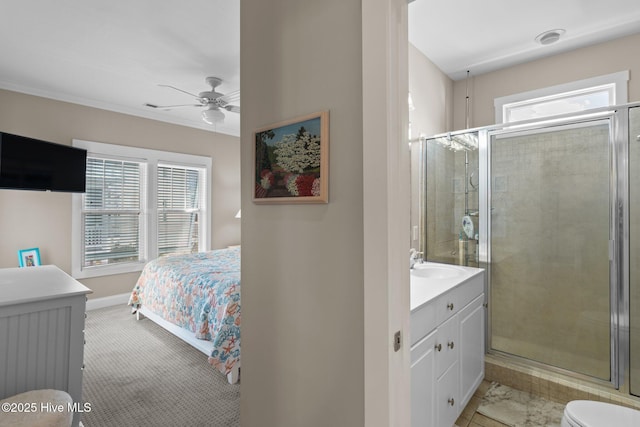 bathroom with ceiling fan, connected bathroom, baseboards, and a stall shower