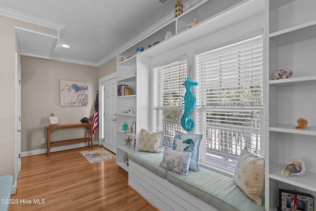 interior space featuring built in features, light wood-type flooring, baseboards, and ornamental molding