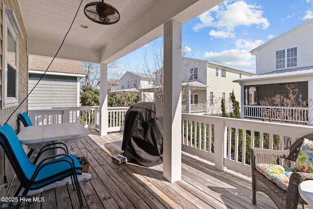 wooden deck featuring ceiling fan