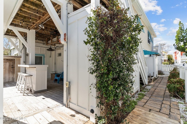 view of home's exterior with a wooden deck and fence