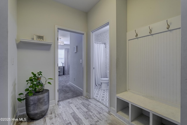 mudroom featuring baseboards and wood finished floors