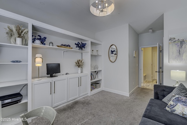 living room with built in features, carpet, a notable chandelier, and baseboards