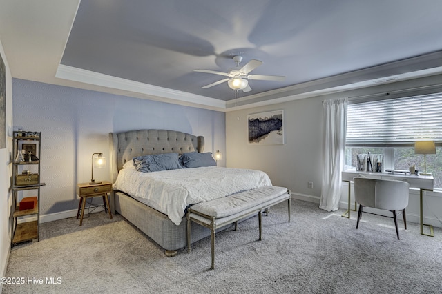 bedroom with carpet, a tray ceiling, and baseboards