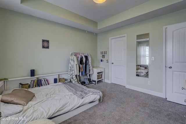 bedroom featuring carpet flooring and baseboards