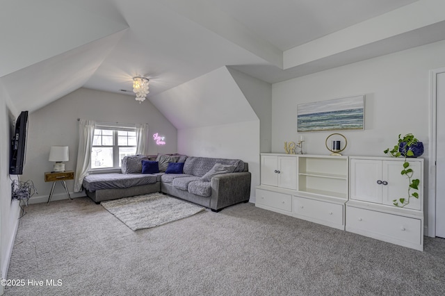 carpeted living area with lofted ceiling