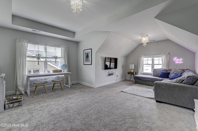 carpeted living area with vaulted ceiling and baseboards